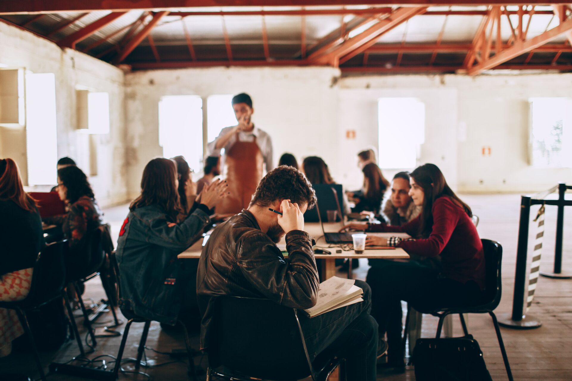 Groups of people sitting around tables, talking.